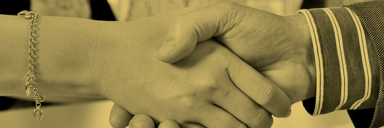 B+W close up photo of two people shaking hands