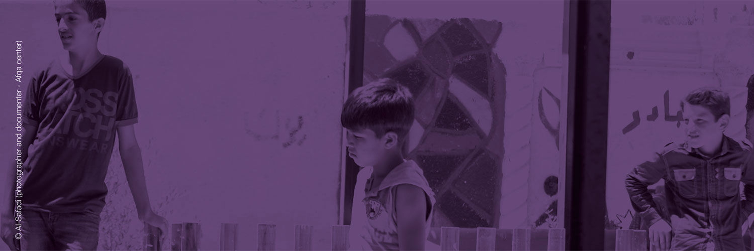 Some children of varying ages standing outside