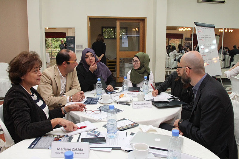A group of professionals having a discussion at the Global Health Organisation meeting in Lebanon