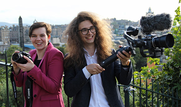 Two QMU students with cameras outside in Edinburgh