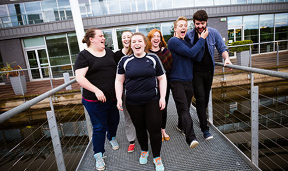 QMU students outside the campus, laughing 