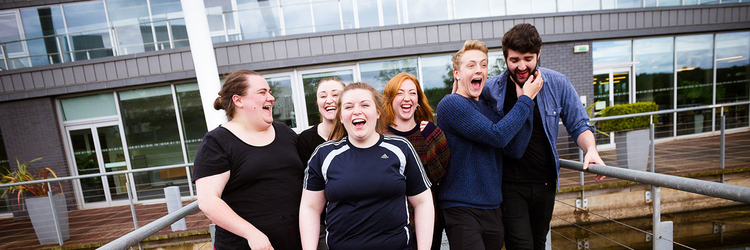 QMU students outside the campus, laughing 