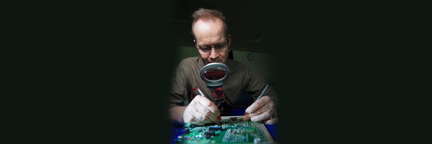 QMU student wiring a circuit board