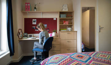 A QMU student at her desk in her student accommodation