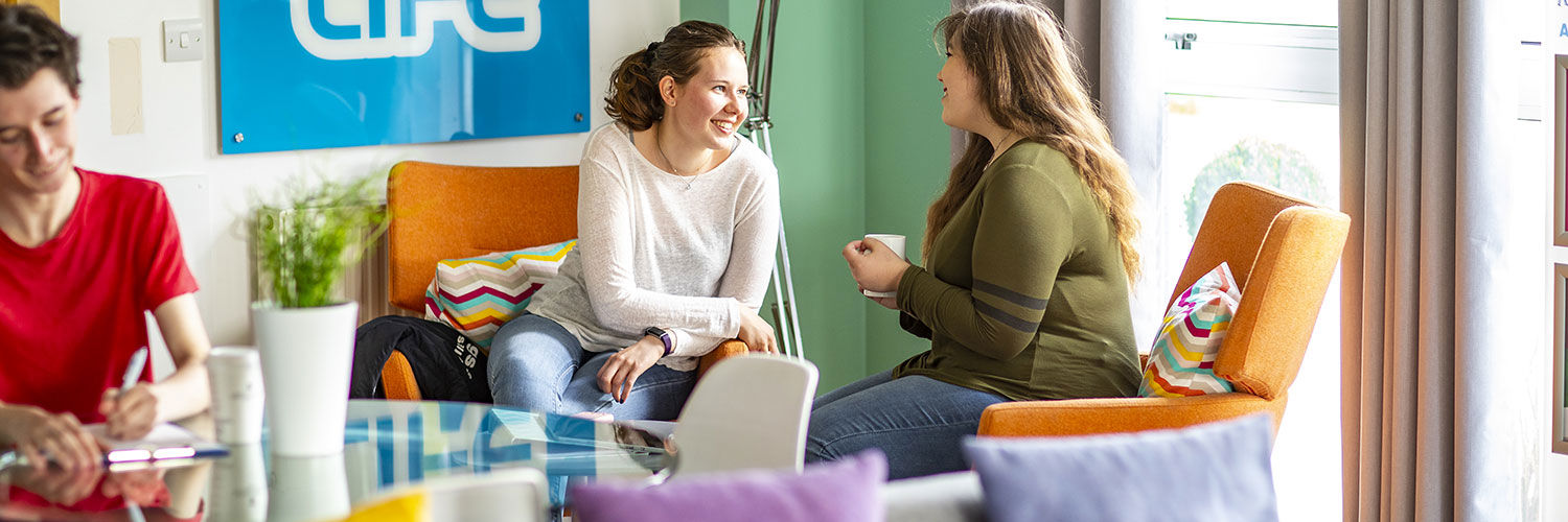 Two Queen Margaret University students enjoying a cup of tea in the accommodation common area