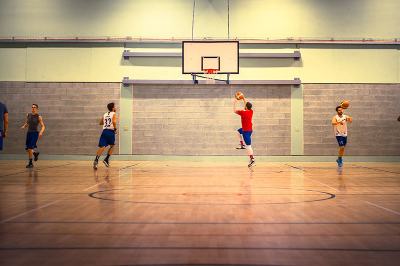 Some QMU students playing basketball 