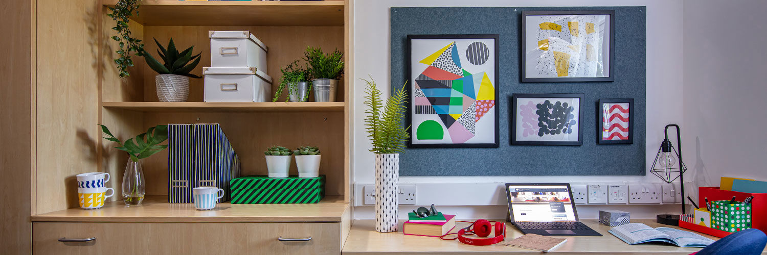 A desk and some shelves in Queen Margaret University campus accommodation