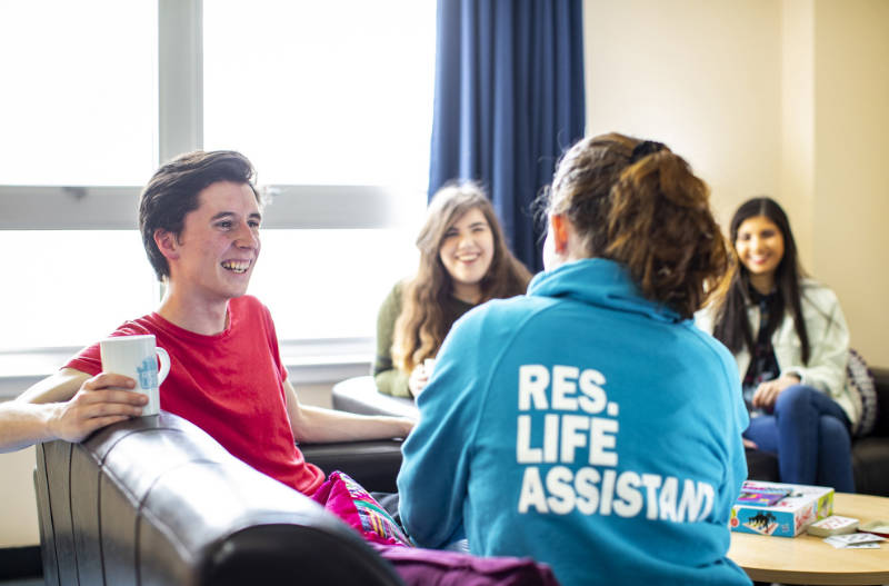 A QMU student talking to a friendly Reslife Assistant