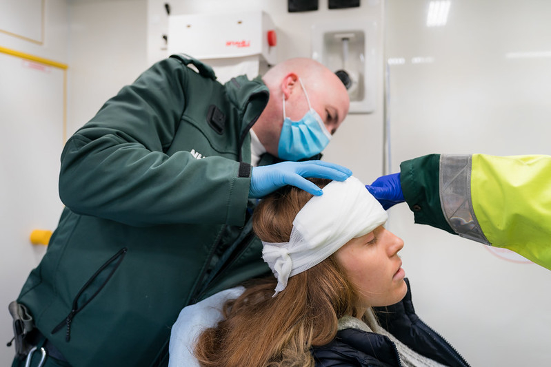Image of Paramedic performing aid on head injury