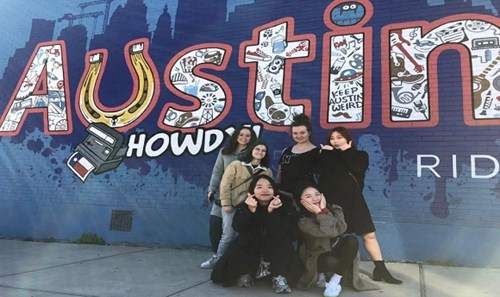Image of group next to 'Austin' mural