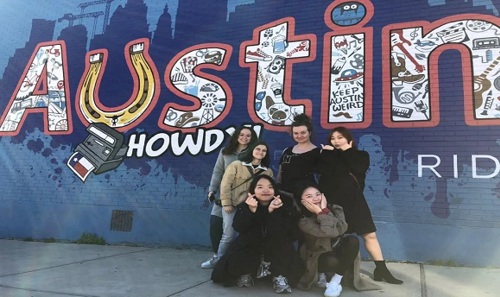 Image of group next to 'Austin' mural