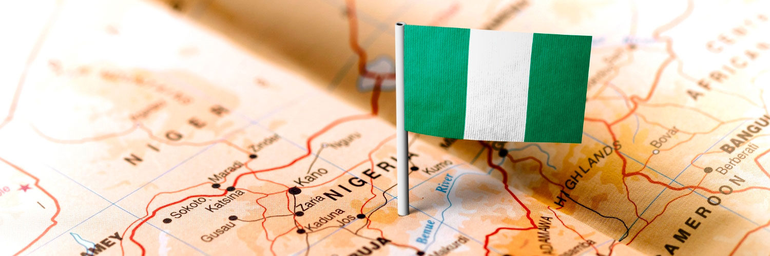 Nigerian flag placed on top of a map of Nigeria