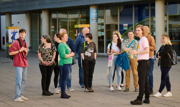 A group of people attending an Open Day event at Queen Margaret University campus.