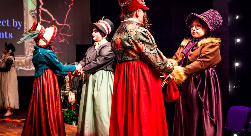 Students on stage in costumes