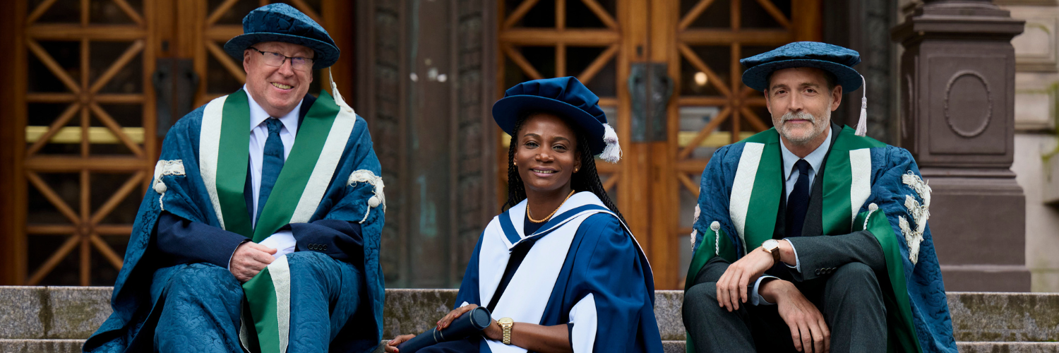 QMU graduate Fatou sat on the steps of the usher hall