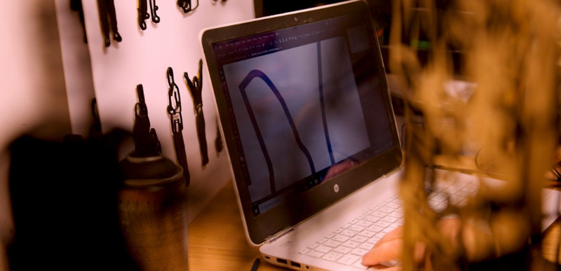 A close up of a laptop screen, where Martha Ellis is drawing her initial designs for the QMU150 anniversary artwork.
