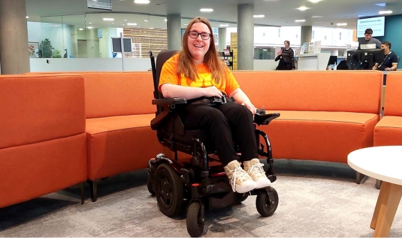 Happy student in a wheelchair in the Learning Resource Centre