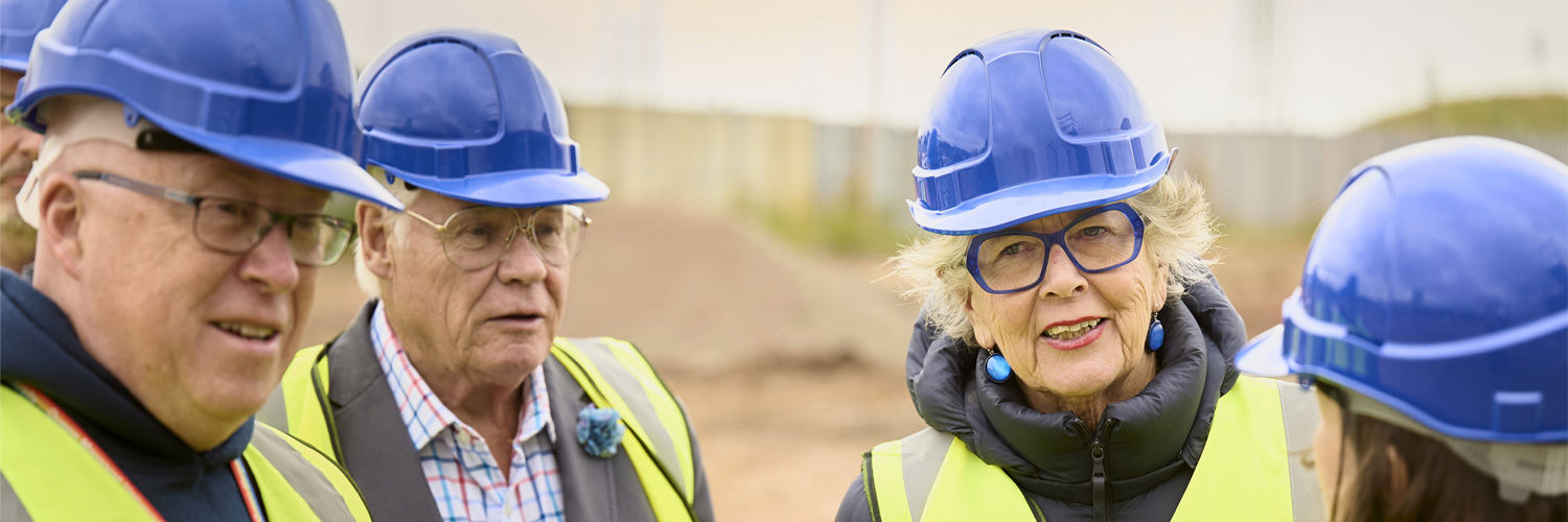 Principal Sir Paul Grice, Dame Prue Leith, and others, attending the building site of the new Edinburgh Innovation Hub.