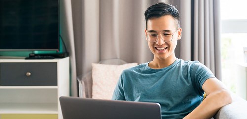 Image of smiling student carrying out online learning