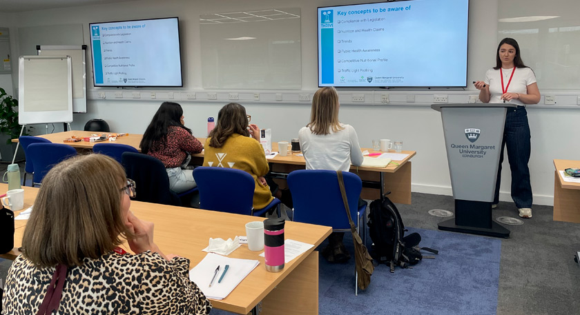 A person presenting on product development to an audience