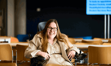 Female student on wheelchair smiling at the camera