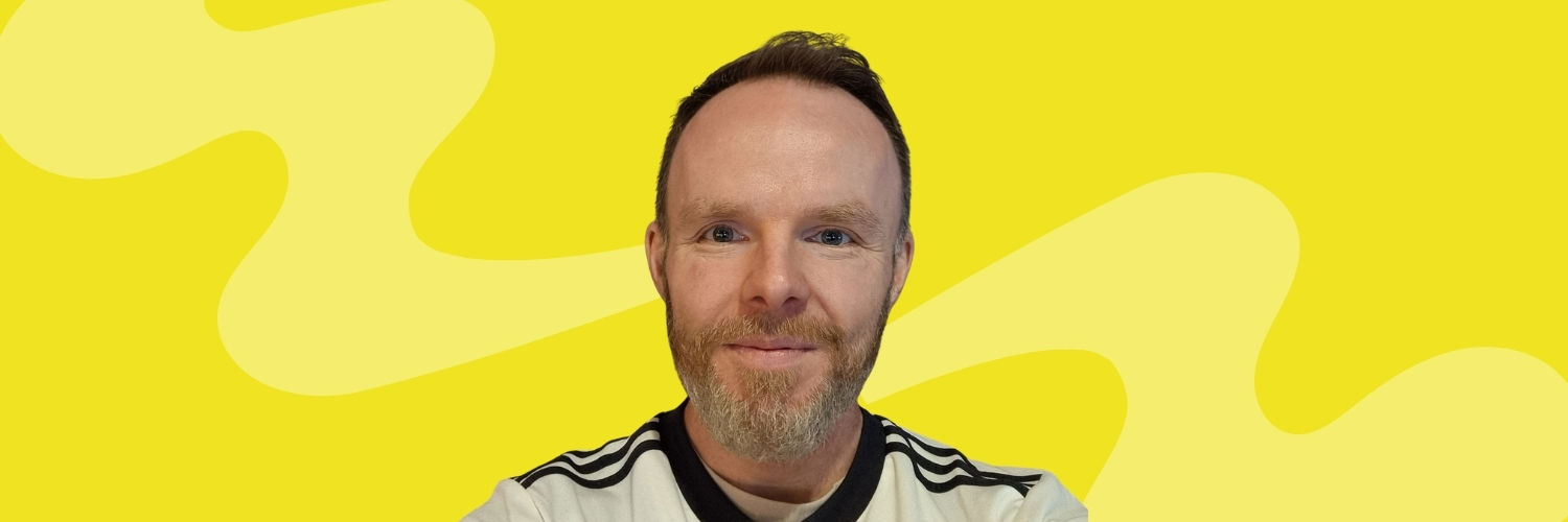 Head and shoulders image of young man on yellow background