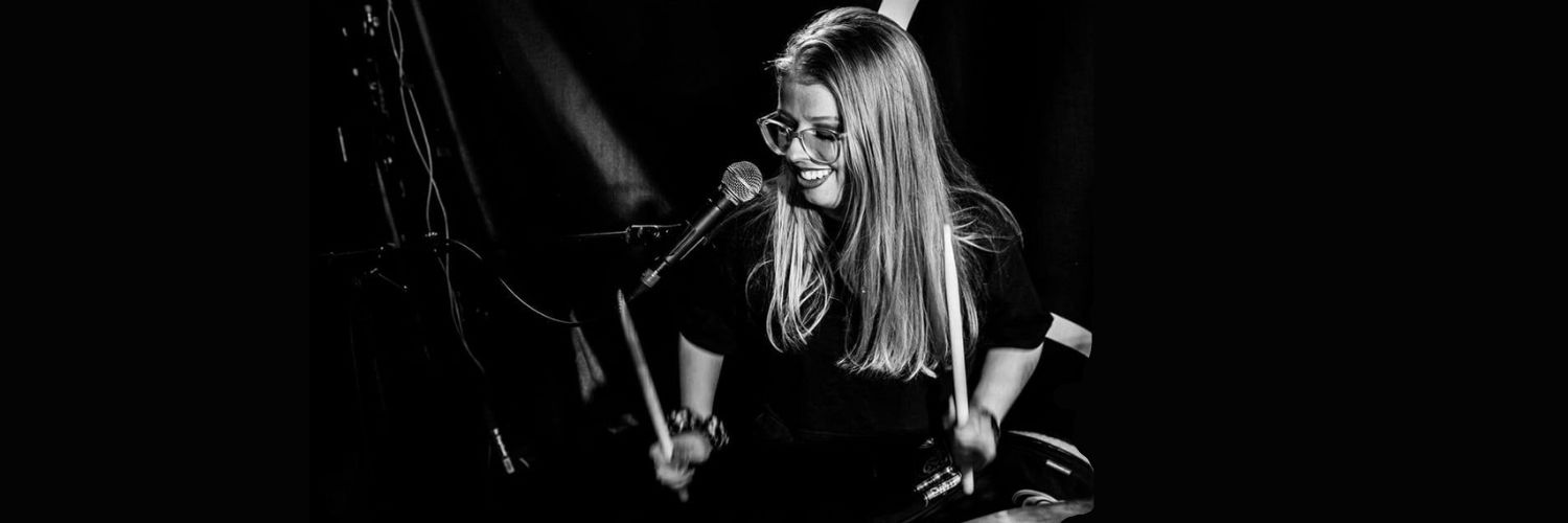 QMU graduate Katie Slater playing the drums