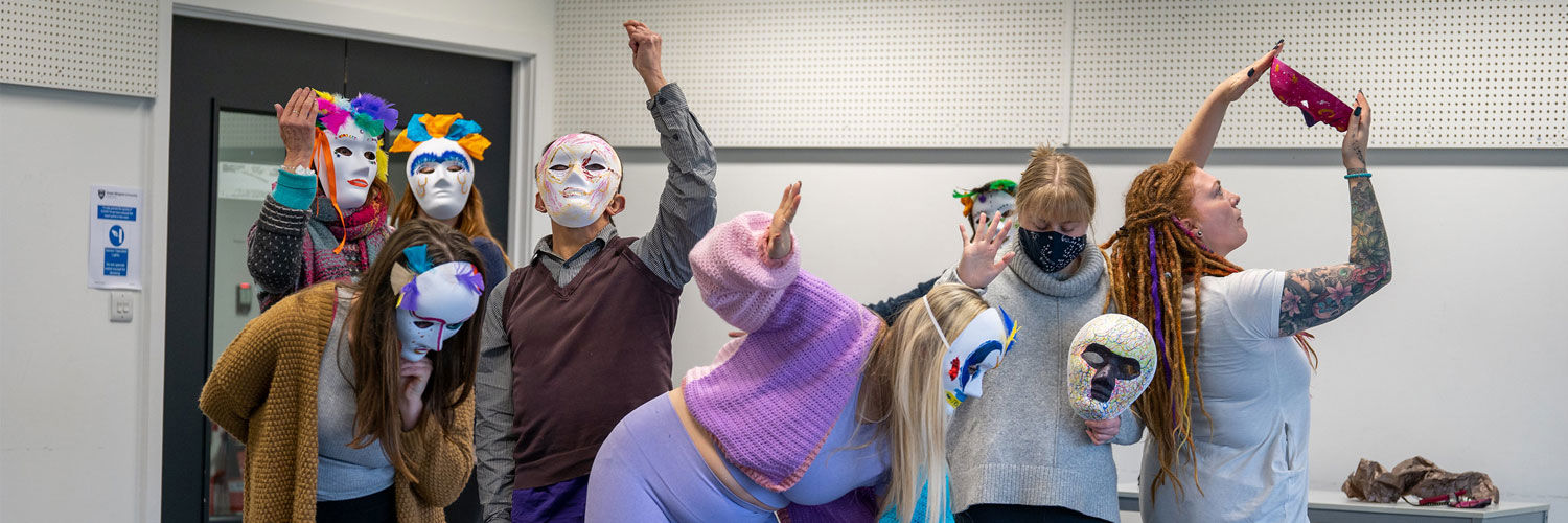 Dramatherapy students performing with a series of different masks on