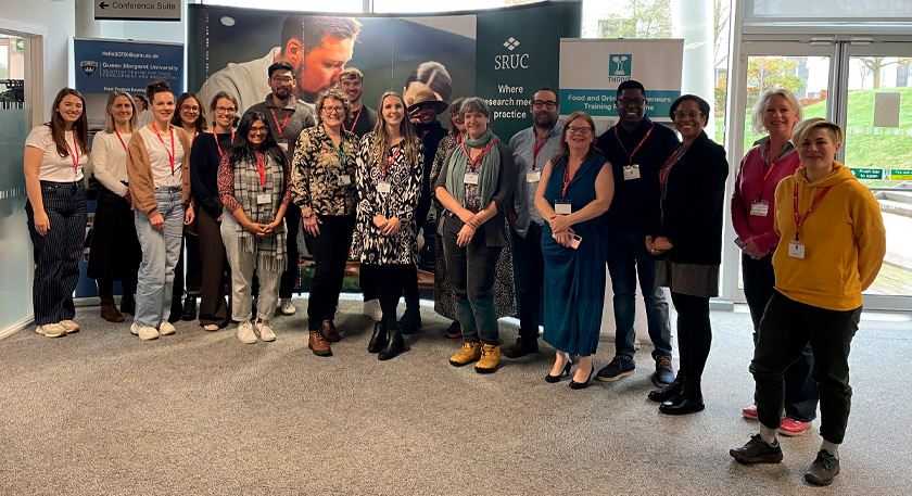 A large group of people smiling at a camera