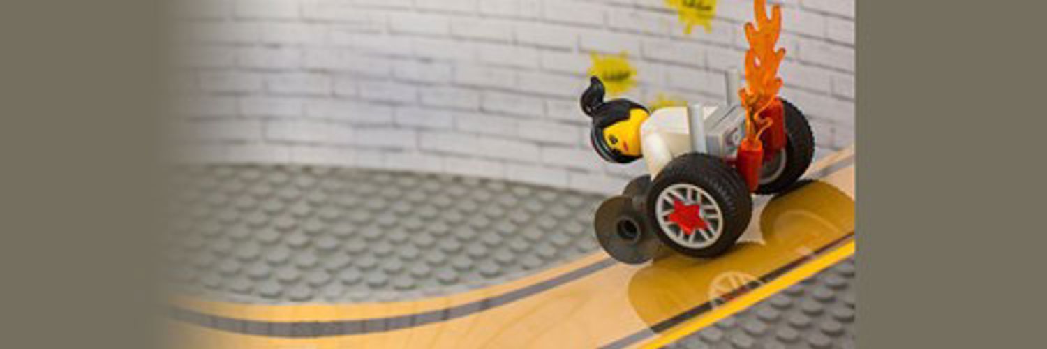 Lego character in a modern wheelchair with stars on the wheels and flames the exterior