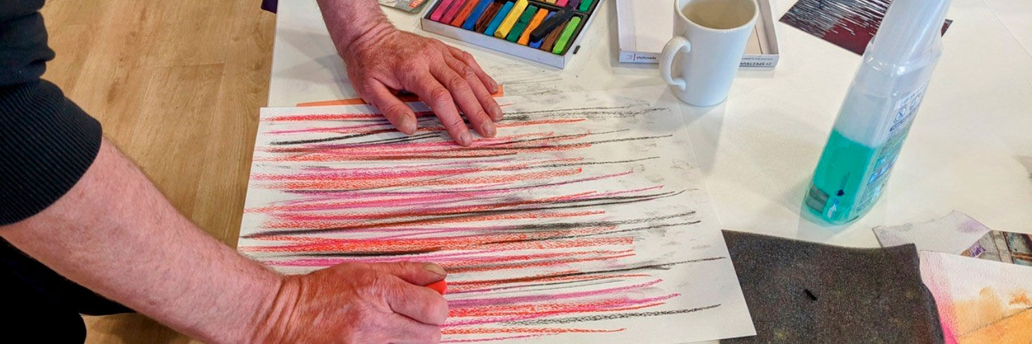 Artwork showing pink, red and black pencil sketch on white paper