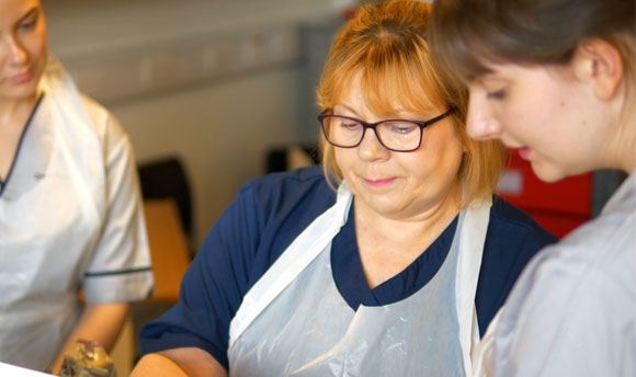 A nursing lecturer alongside student nurses in one of our teaching facilities.