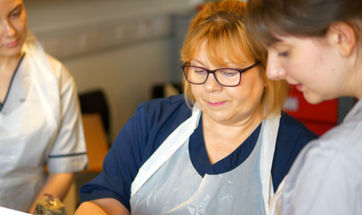 A nursing lecturer alongside student nurses in one of our teaching facilities.
