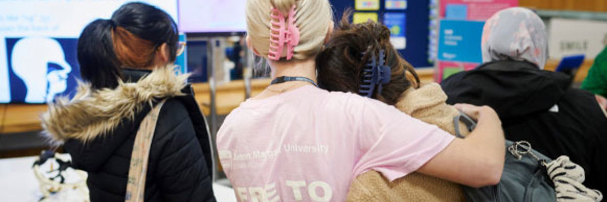 Two QMU students hugging