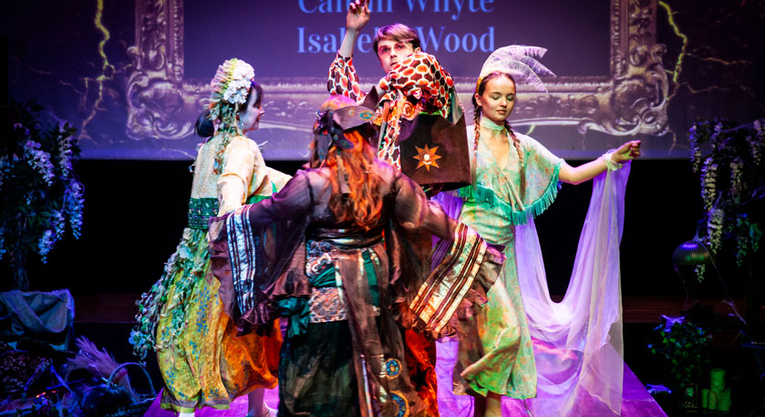 Students on stage in costumes