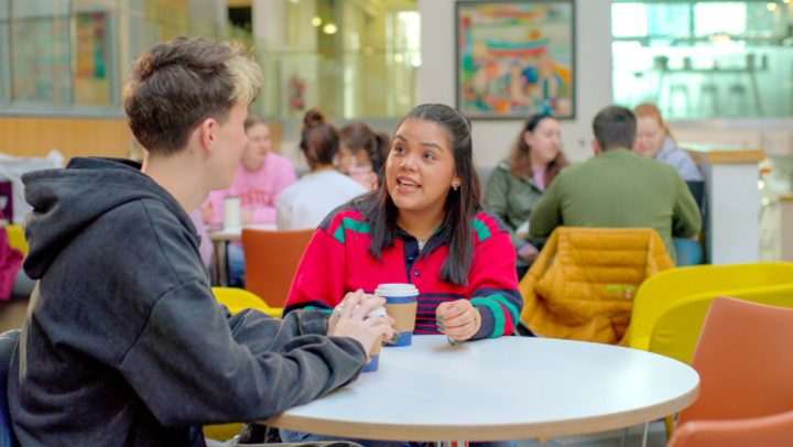 male and female student talking to each other at QMU