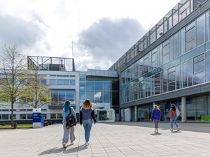 Image of students and staff walking into QMU campus