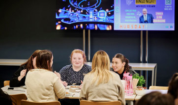 A group of QMU students sat around a table