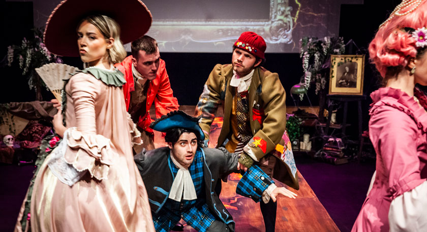 Students on stage in costumes