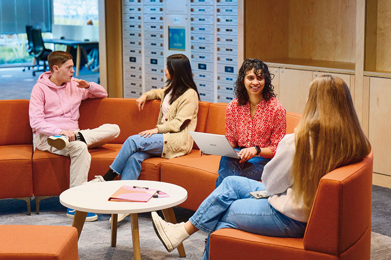 Photo of students chatting on comfortable sofa in our Learning Resource Centre