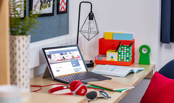 Laptop set up on desk within student accommodation