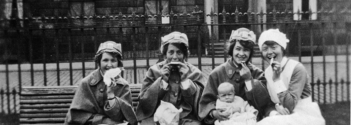 Black and White photo of Princess Louise Nurses enjoying food on a bench in 1922