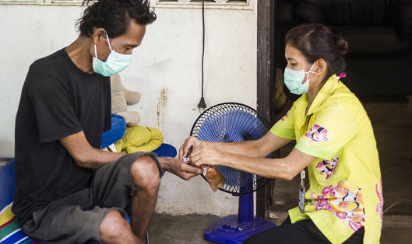 IMPACT tuberculosis study medical staff dispensing medicine to patient