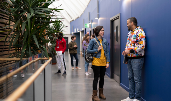 Students chatting outside QMU Lecture Theatres and Seminar Rooms
