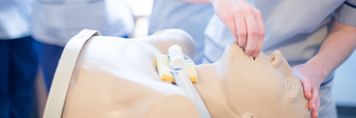 nursing students practicing with a dummy 