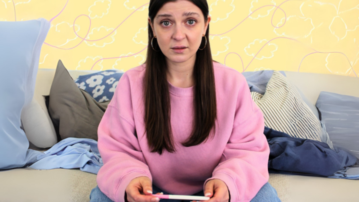woman holding pregnancy test
