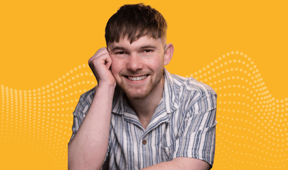 A photograph of Alexander smiling at the camera over a yellow background