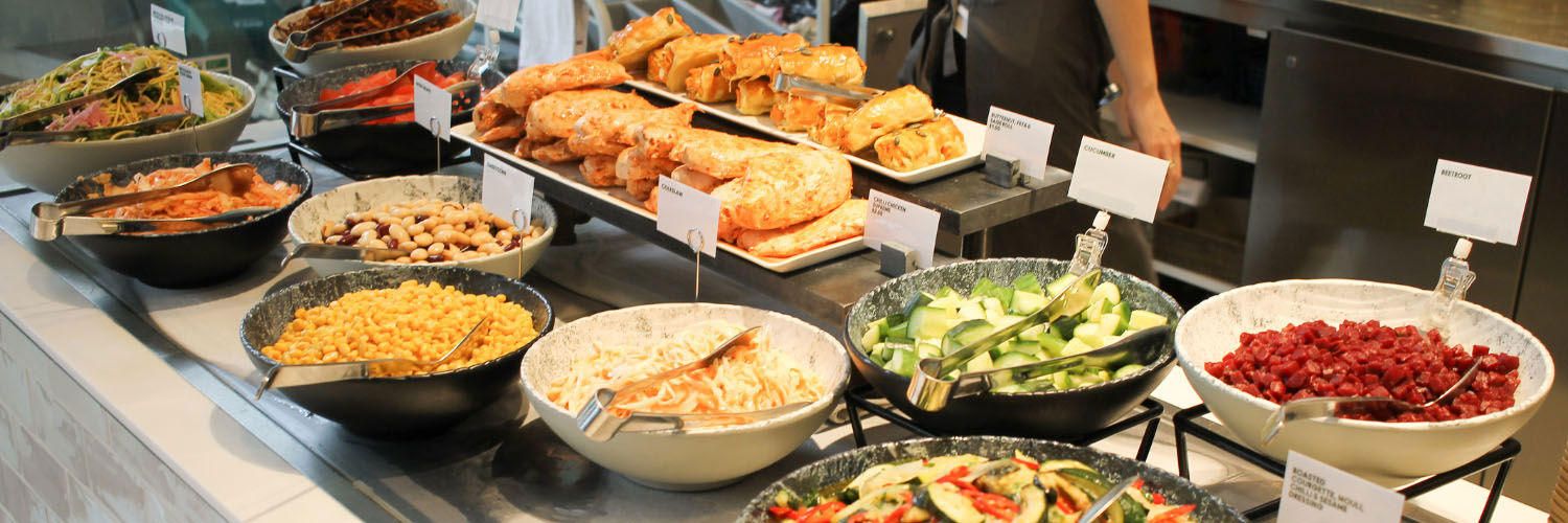 An assortment of fresh food served up at a food counter.