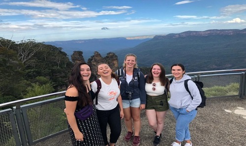 Image of friends smiling at viewpoint