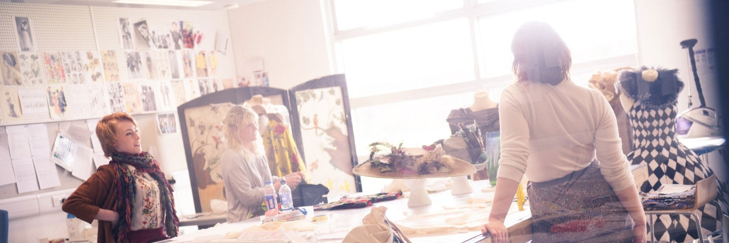 A group of students making costumes in a workshop.